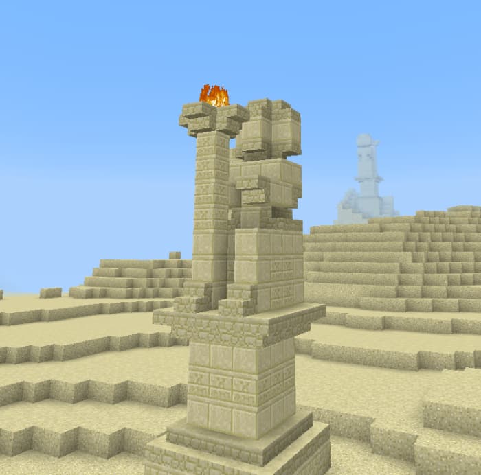 Руины статуи из песка